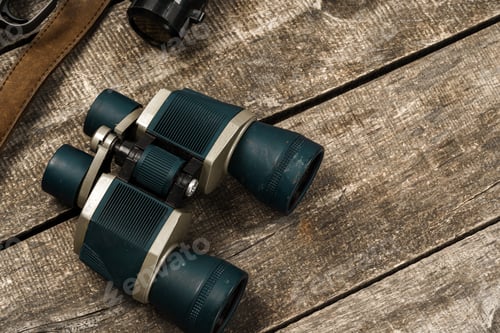 Preview: Hunting equipment binoculars on wooden background close up