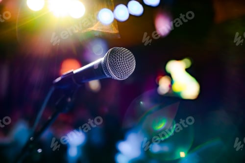 Preview: Microphone on stage against a background of auditorium.