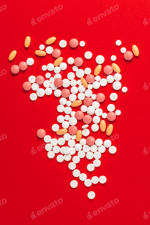 Preview: White pills spilling out of a toppled white bottle on red background