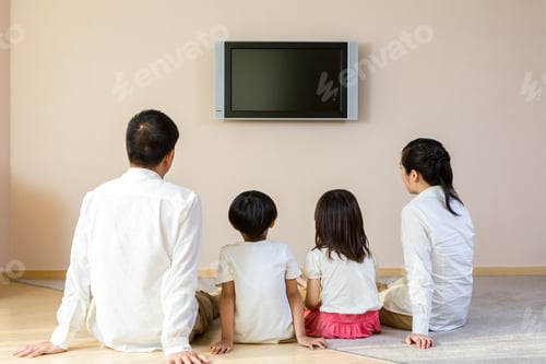 Preview: Happy family watching TV at home