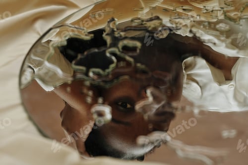 Preview: Reflection of black woman in mirror
