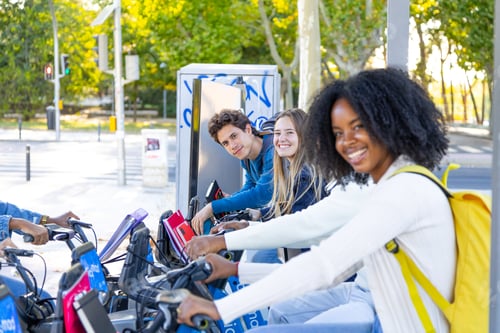 Preview: Diverse young people enjoying urban bike sharing together