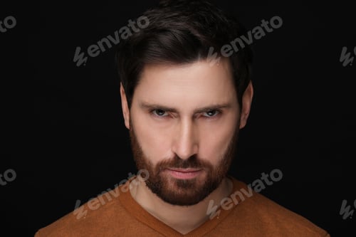 Preview: Evil eye. Man with scary eyes on black background, closeup