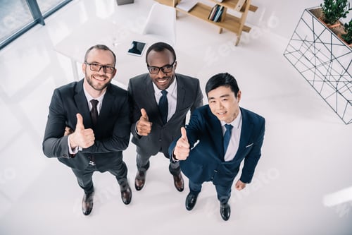 Preview: group of multiethic businessmen showing thumbs up