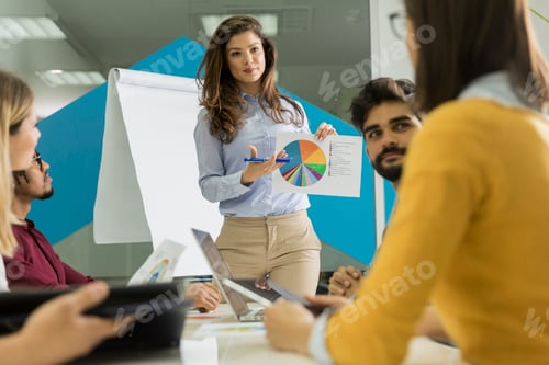 Preview: Conversation among young workers at small startup company with paper chart