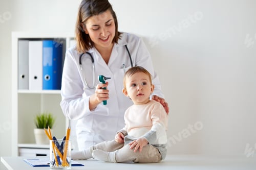 Preview: doctor with baby and otoscope at clinic