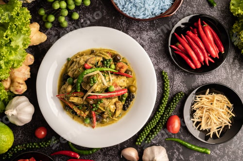 Preview: Stir Fried Spicy Chicken in white plate with spices on black cement.
