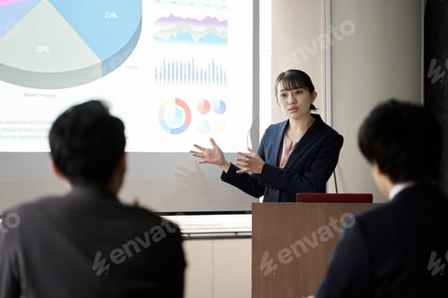 Preview: Asian business woman presenting at a conference