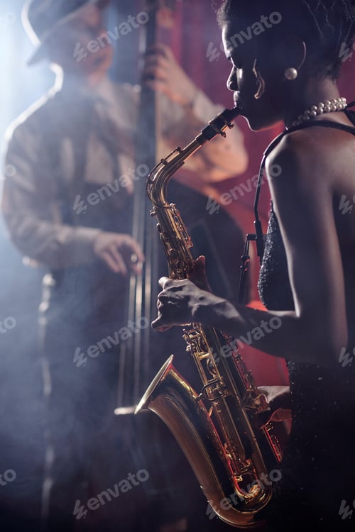 Preview: Young Female Musician Playing Saxophone While Jazz Bassist Performing Live