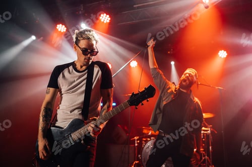 Preview: Rock band performing live on stage with energetic singer and guitarist