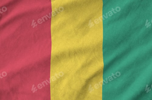 Preview: Guinea flag depicted on folded wavy fabric of old cloth