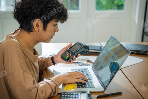 Preview: Happy women using credit card for online shopping at the living room,Showing credit card.