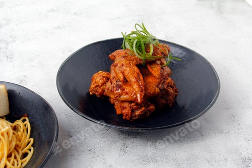 Preview: Plateful of Spicy Chicken Wings with Noodles