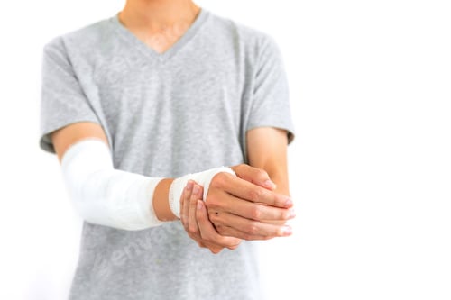 Preview: Young man with gauze bandage wrapped around injury hand on white background