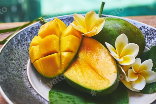Preview: Fresh mango on a wooden tabel with tropical background. Soft focus.