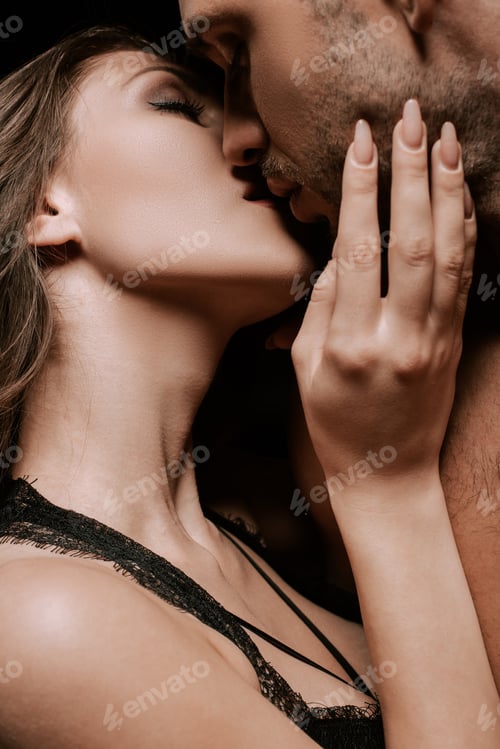 Preview: passionate girl with closed eyes kissing handsome man