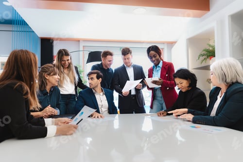 Preview: Multiracial business team working together in a boardroom of modern office