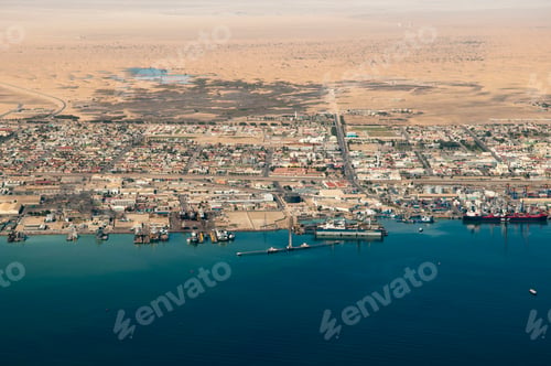 Preview: Aerial view of a coastal town next to a vast desert