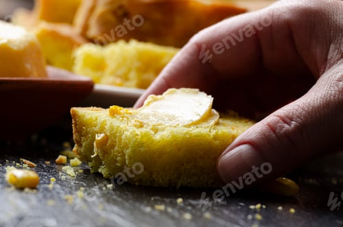 Preview: Slices of homemade cornbread and butter on kitchen table