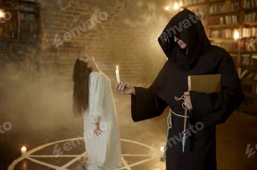 Preview: Exorcist in hood casting out demons from a woman