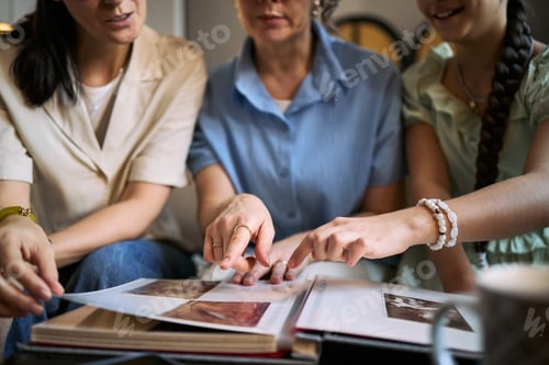 Preview: Adult Women and Teenage Girl Reviewing Family Photo Album