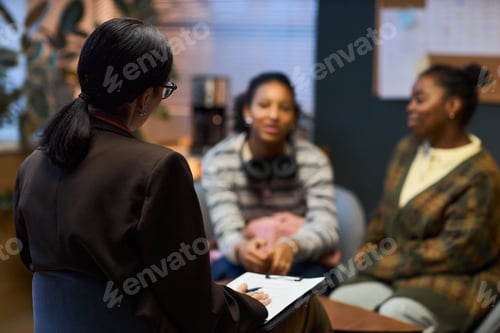 Preview: Middle Aged Caucasian Woman Meeting with Two Black Teen Girls in Office