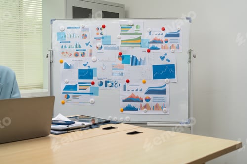 Preview: A graph displayed on a board in conference room illustrates key business metrics.The professional