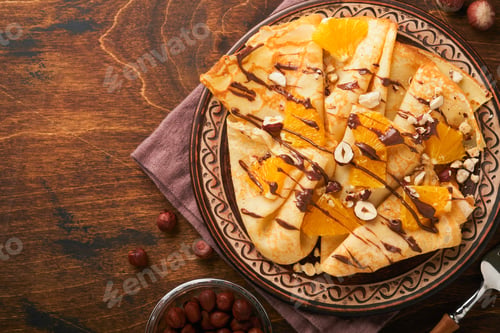 Preview: Crepes suzette with oranges and chocolate. Thin crepes with chocolate spread, hazelnuts and orange s
