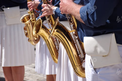 Preview: Midsection of people playing saxophone in orchestra
