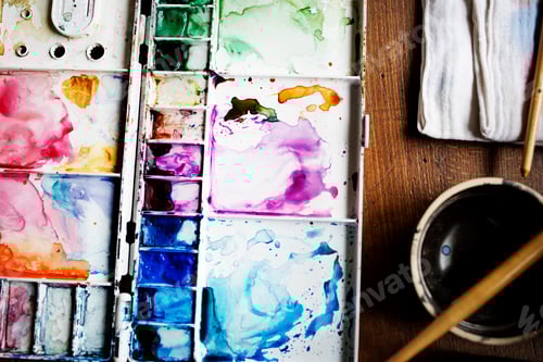 Preview: Colorful Watercolor Paints in Palette on Wood Table