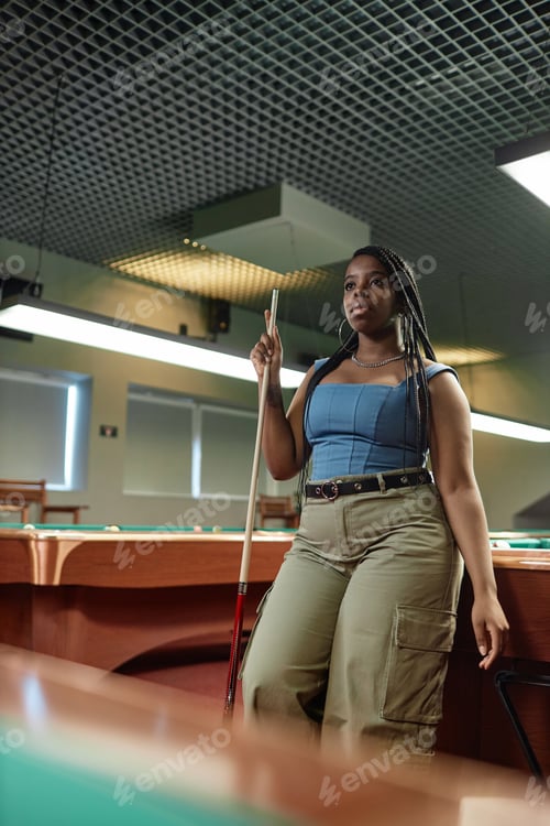 Preview: African American woman playing pool