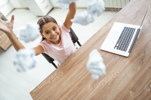 Preview: The happy girl throwing a piece of paper at the desk