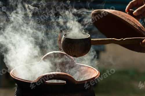 Preview: Handle spoon dipper over the smoke from traditional clay hot pot