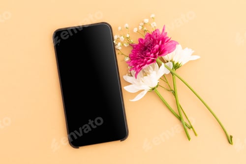 Preview: Smartphone with blank screen and pink and white flowers on yellow background