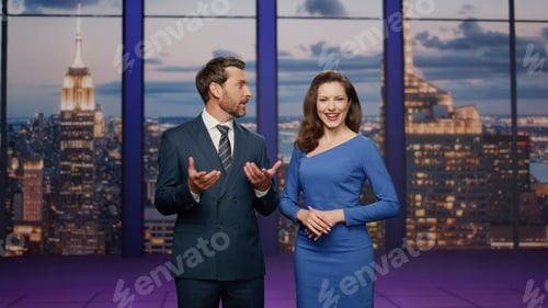 Preview: Friendly anchors smiling studio television channel. Couple newsreaders reporting