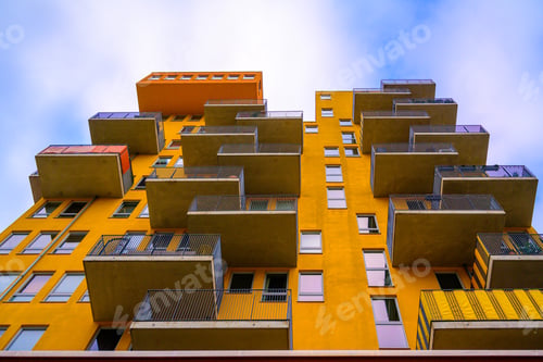 Preview: Modern apartment building with a bright yellow facade, creating a vibrant visual impact