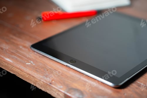 Preview: Tablet on Wooden Surface with Red Pen