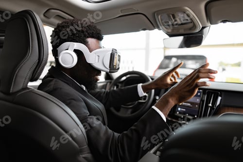 Preview: Businessman exploring car interior using virtual reality headset in dealership