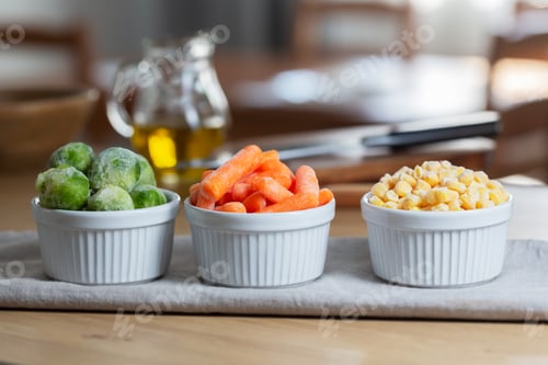 Preview: Frozen vegetables in the bowls on the kitchen table, horizontal