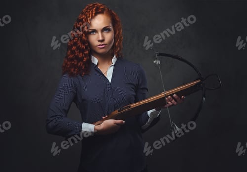 Preview: Redhead female holds crossbow.