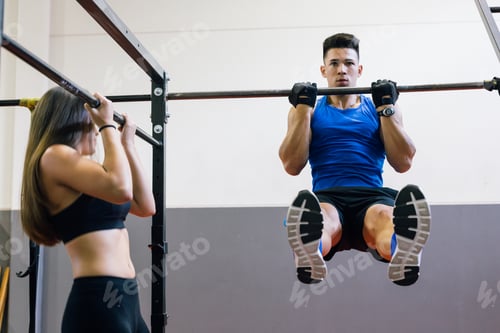 Preview: Woman doing pullups at the gym