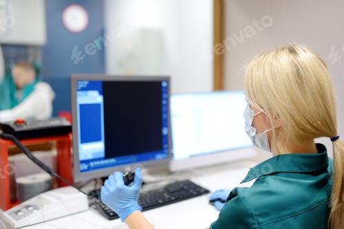 Preview: Female radiologist is going to take X ray of patient in X-ray room of modern clinic.