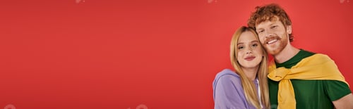 Preview: portrait of young couple looking at camera on coral background, vibrant colors, stylish outfits,