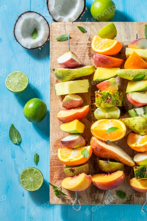 Preview: Fresh Fruit Skewers on a Blue Wooden Table