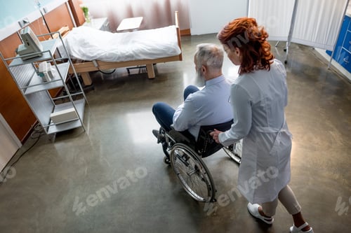 Preview: High angle view of female doctor pushing senior patient in wheelchair