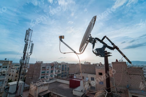 Preview: TV satellite dish with sunset sky in the background