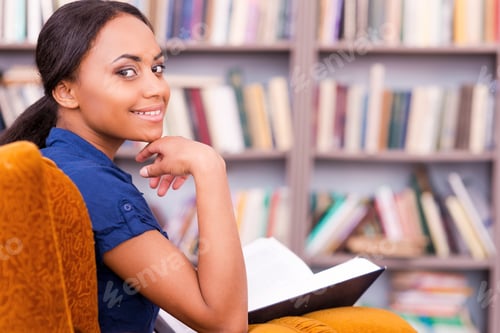 Preview: Reading a book in library.