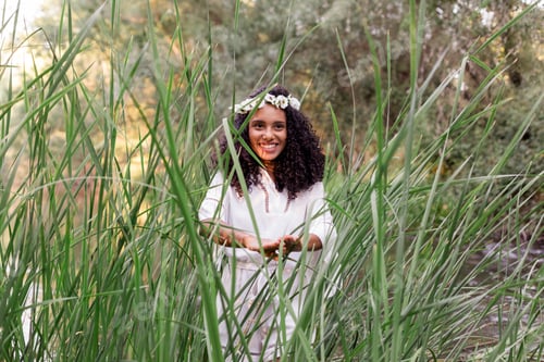 Preview: smiling beautiful young afro american woman at sunset. Lifestyle and nature