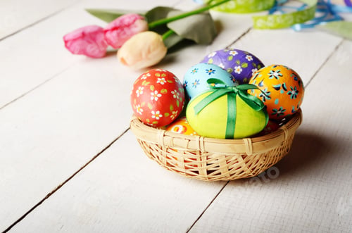 Preview: Rustic style painted easter eggs in basket on white table