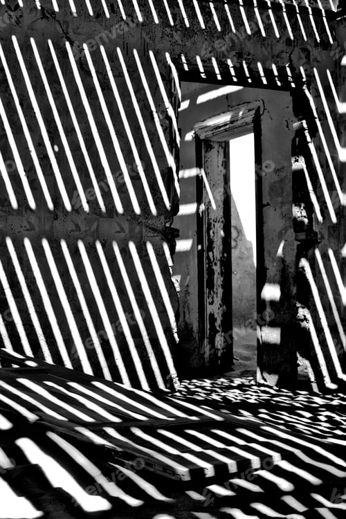 Preview: Vertical shot of an abandoned house interior with shadows in ghost town Kolmanskop, Namibia